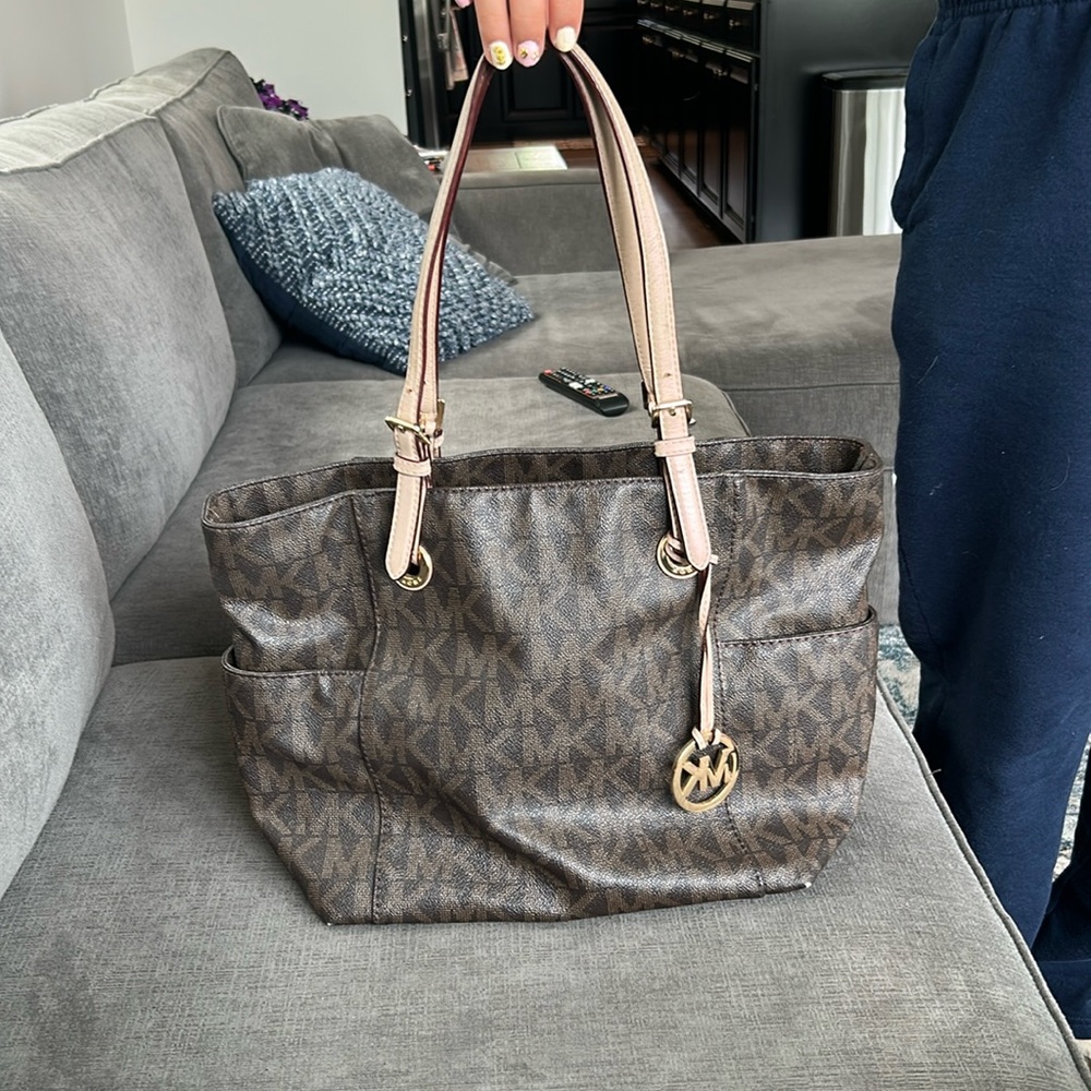 Brown monogram Michael Kors  purse. Some minor wear and tear. See picture